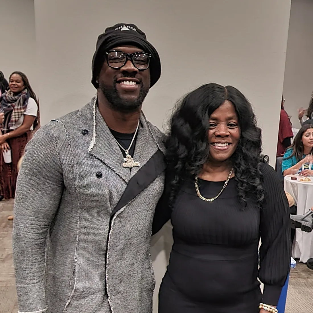 A TBAH leader smiles beside a guest speaker at an evening event